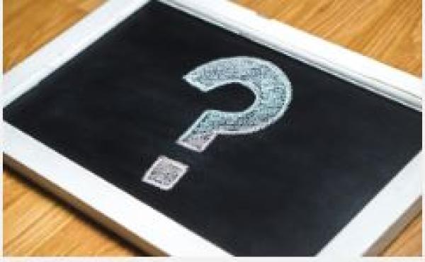 Question mark written in chalk on blackboard